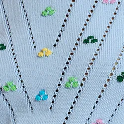 Light blue pointelle-knitted sweater with embroideries