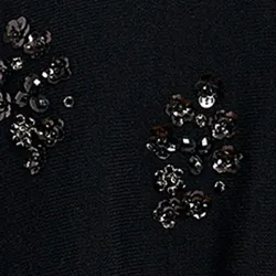 Black cape-effect knit sweater with embellishments