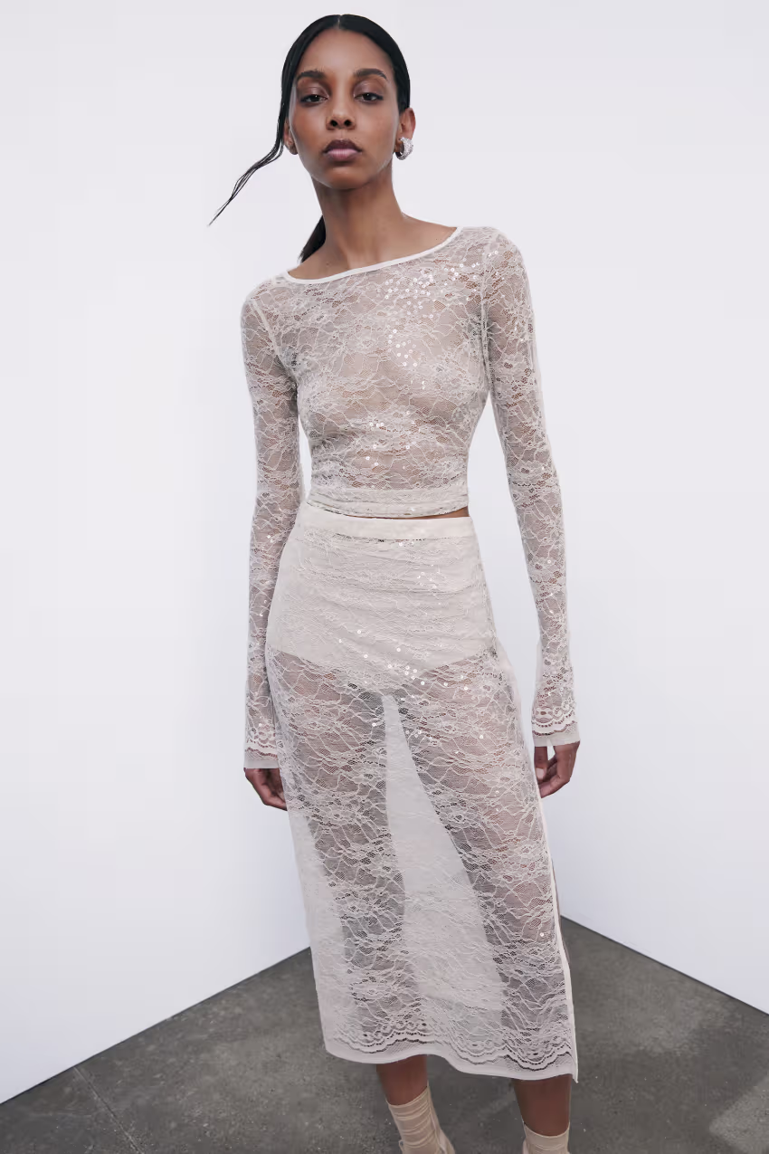 Top a maniche lunghe in pizzo con paillettes