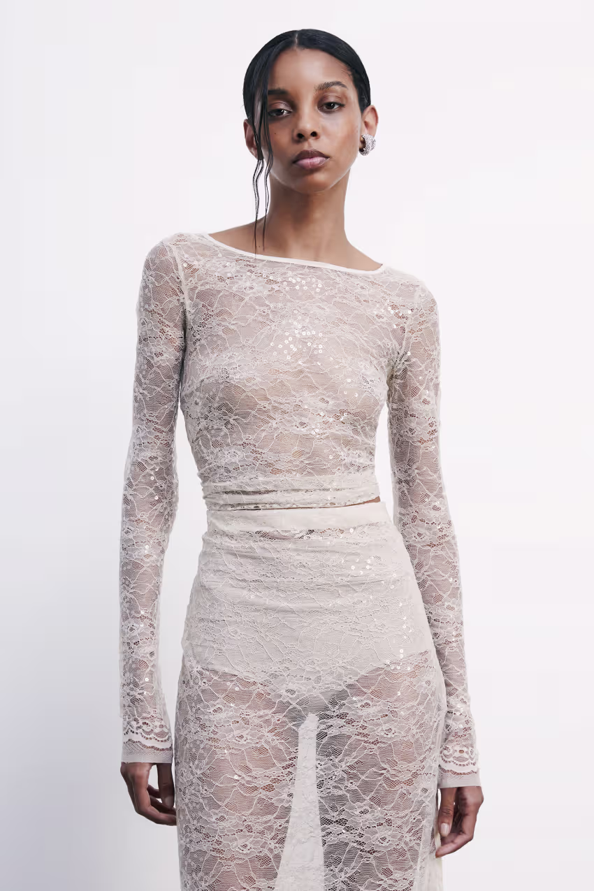 Top a maniche lunghe in pizzo con paillettes