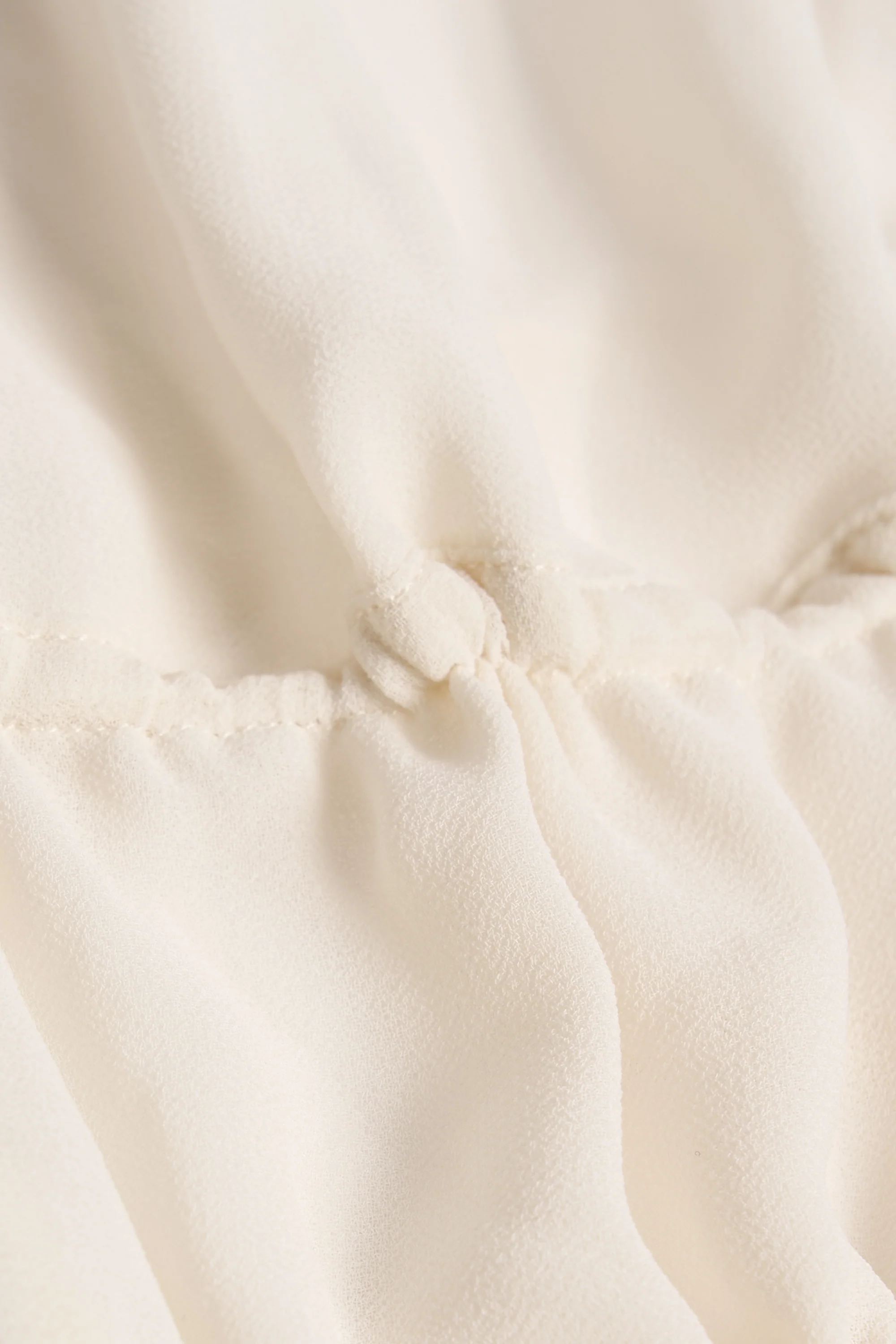 Cut-Out Semi-Sheer Ruched Halterneck Crop Top in Ivory