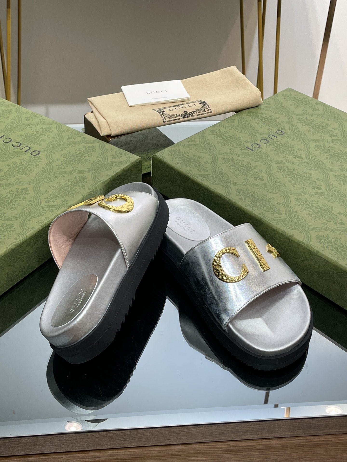 Gucci slippers with gold logo lettering buckle
