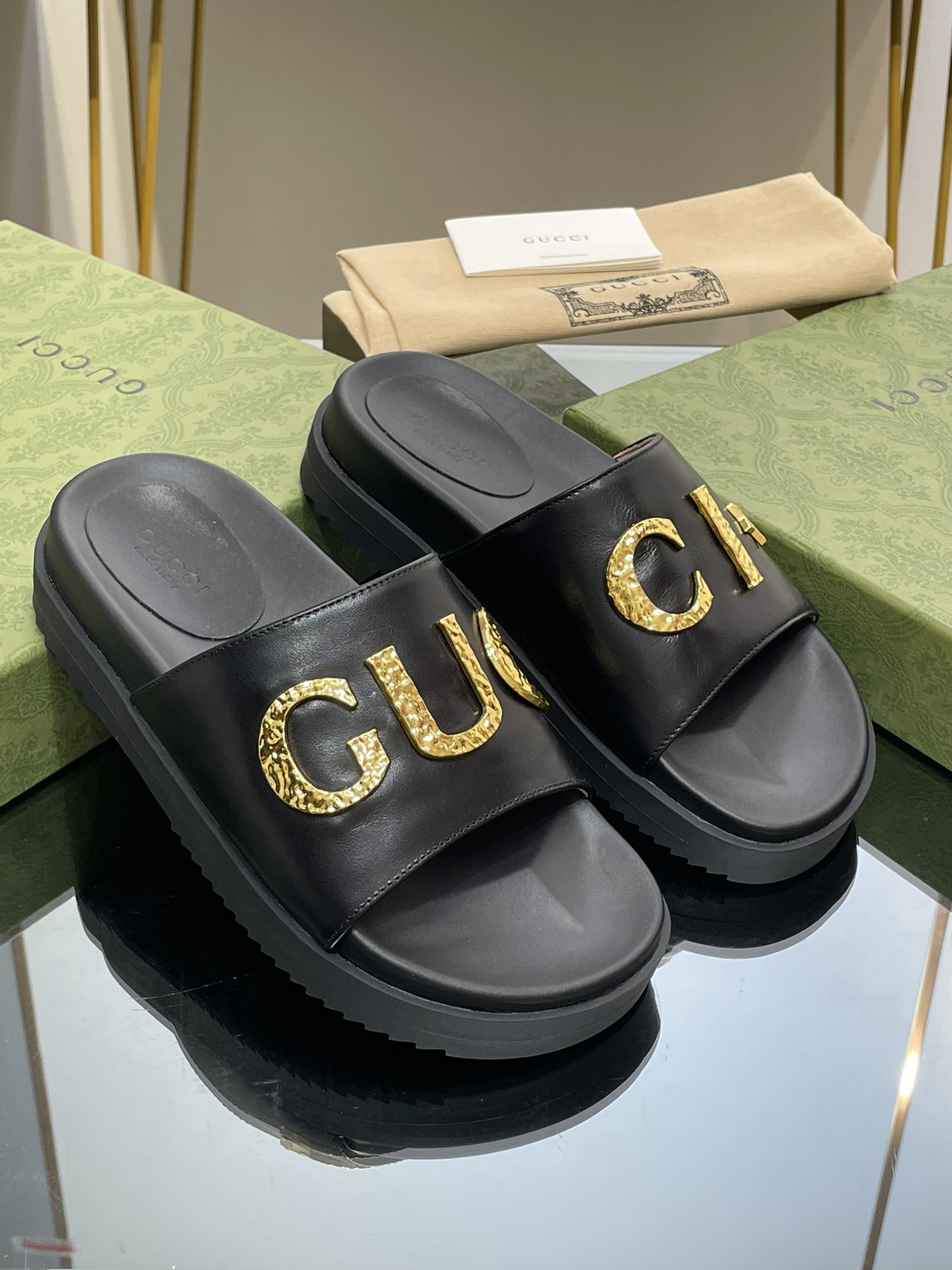 Gucci slippers with gold logo lettering buckle