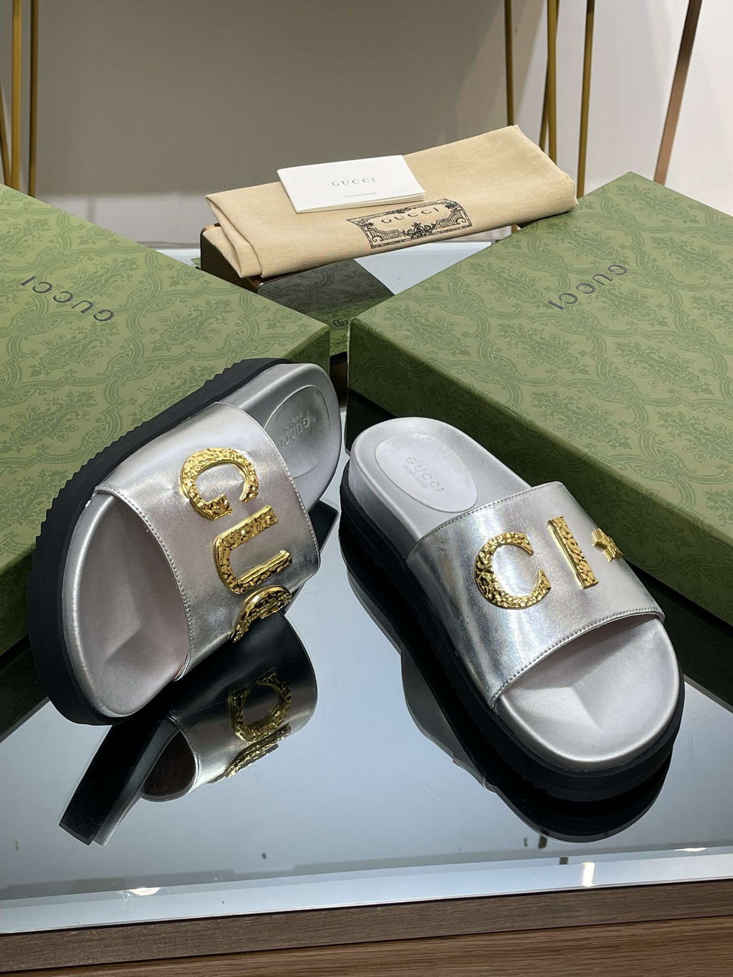 Gucci slippers with gold logo lettering buckle
