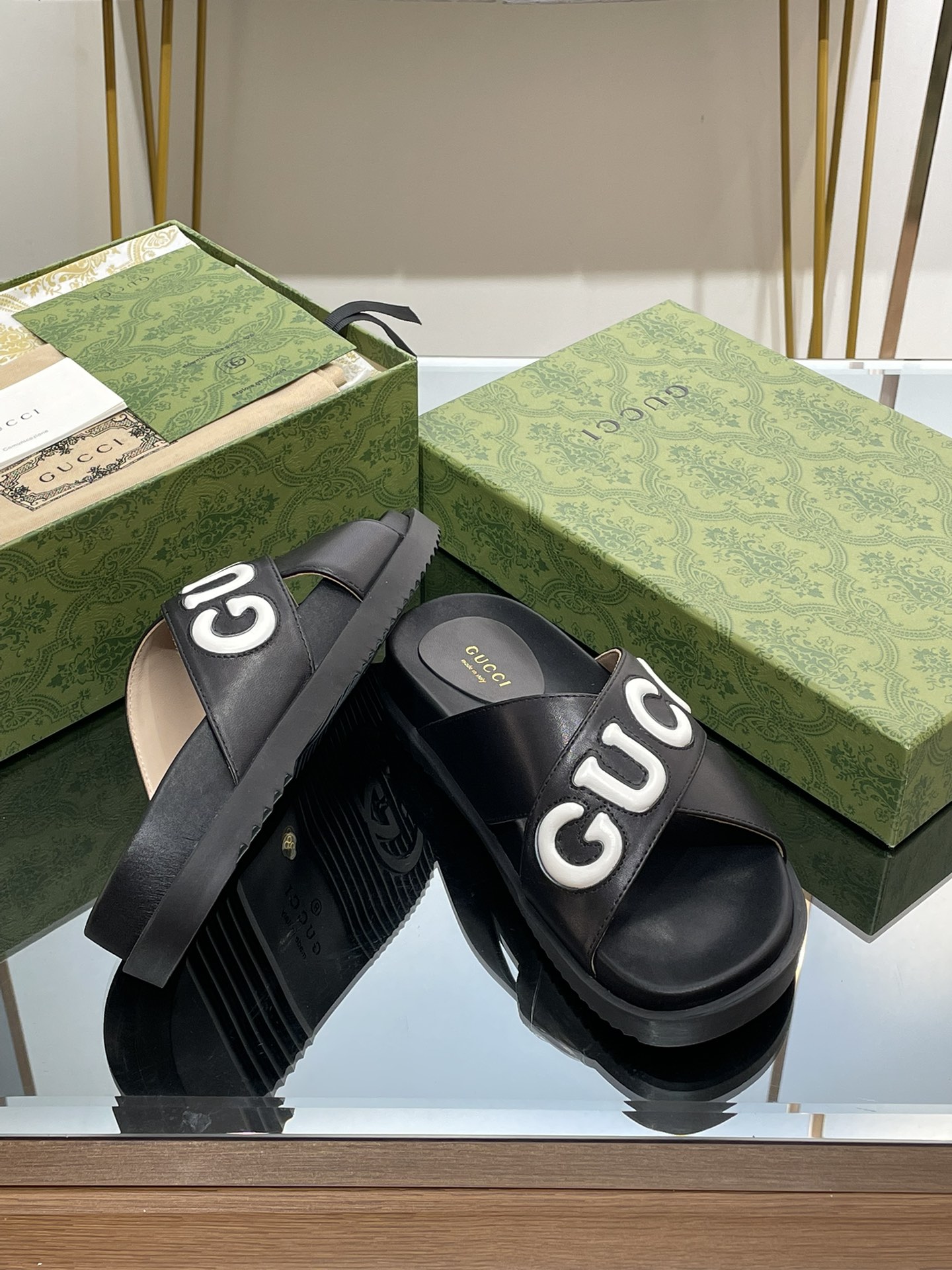 Gucci slippers with large logo lettering cross straps