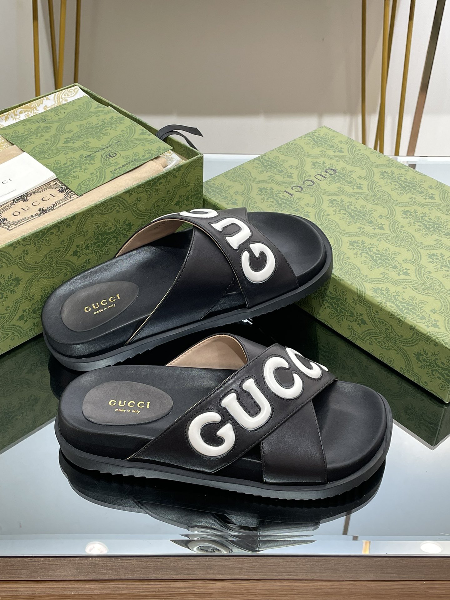 Gucci slippers with large logo lettering cross straps