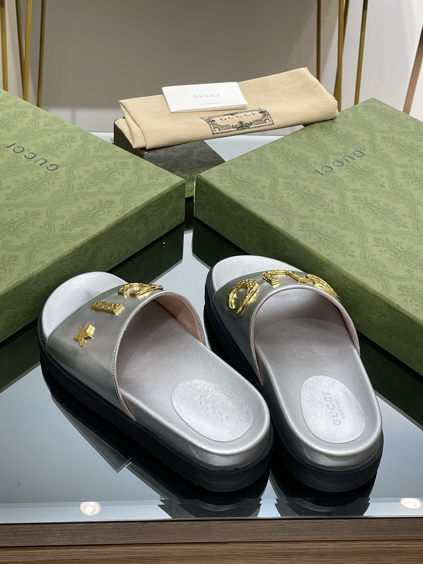 Gucci slippers with gold logo lettering buckle