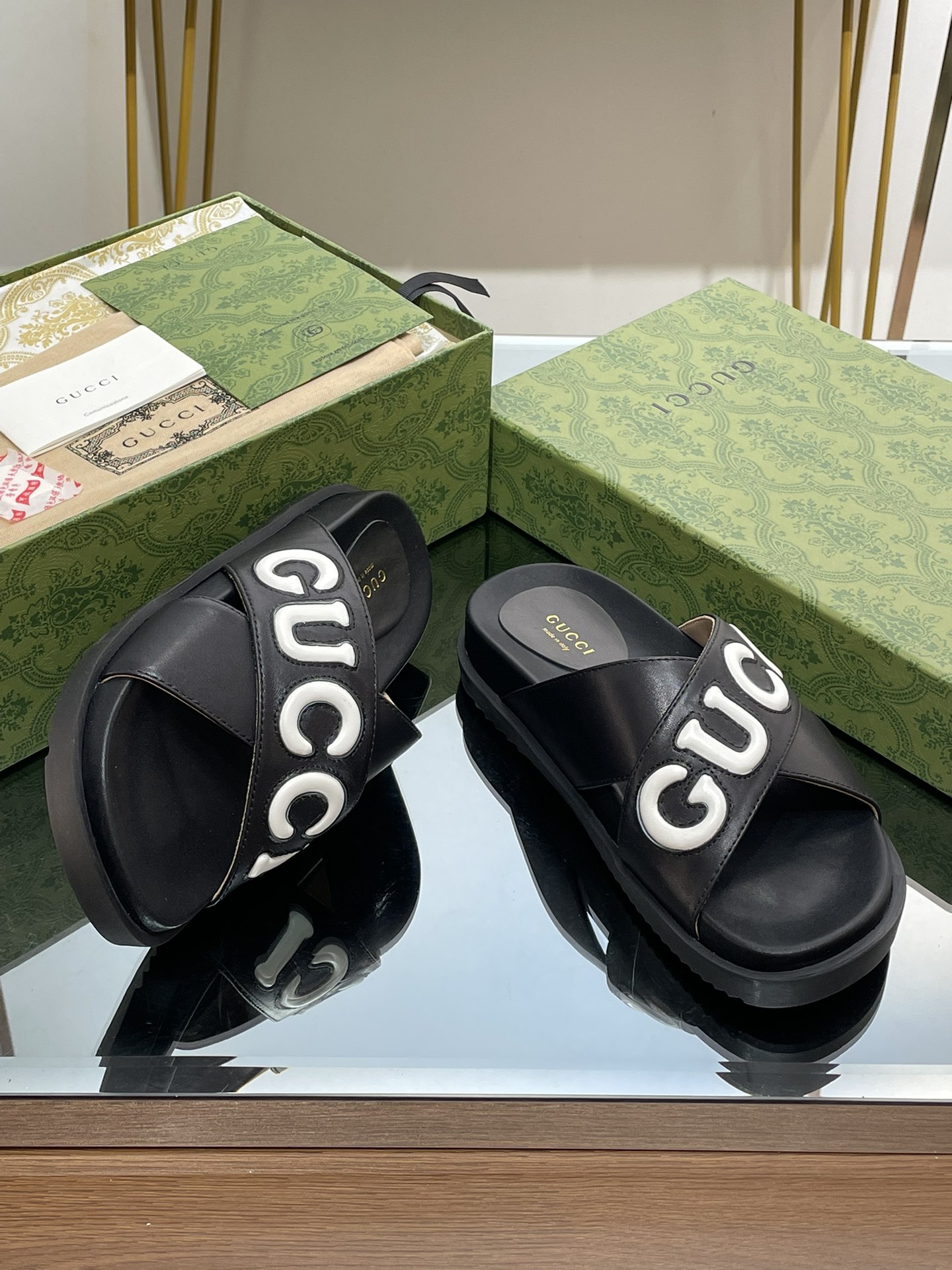 Gucci slippers with large logo lettering cross straps