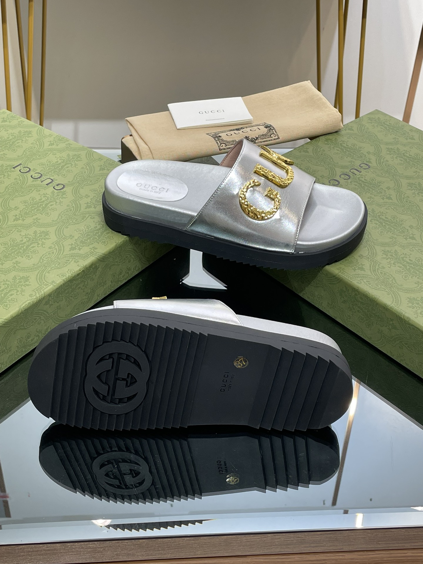 Gucci slippers with gold logo lettering buckle