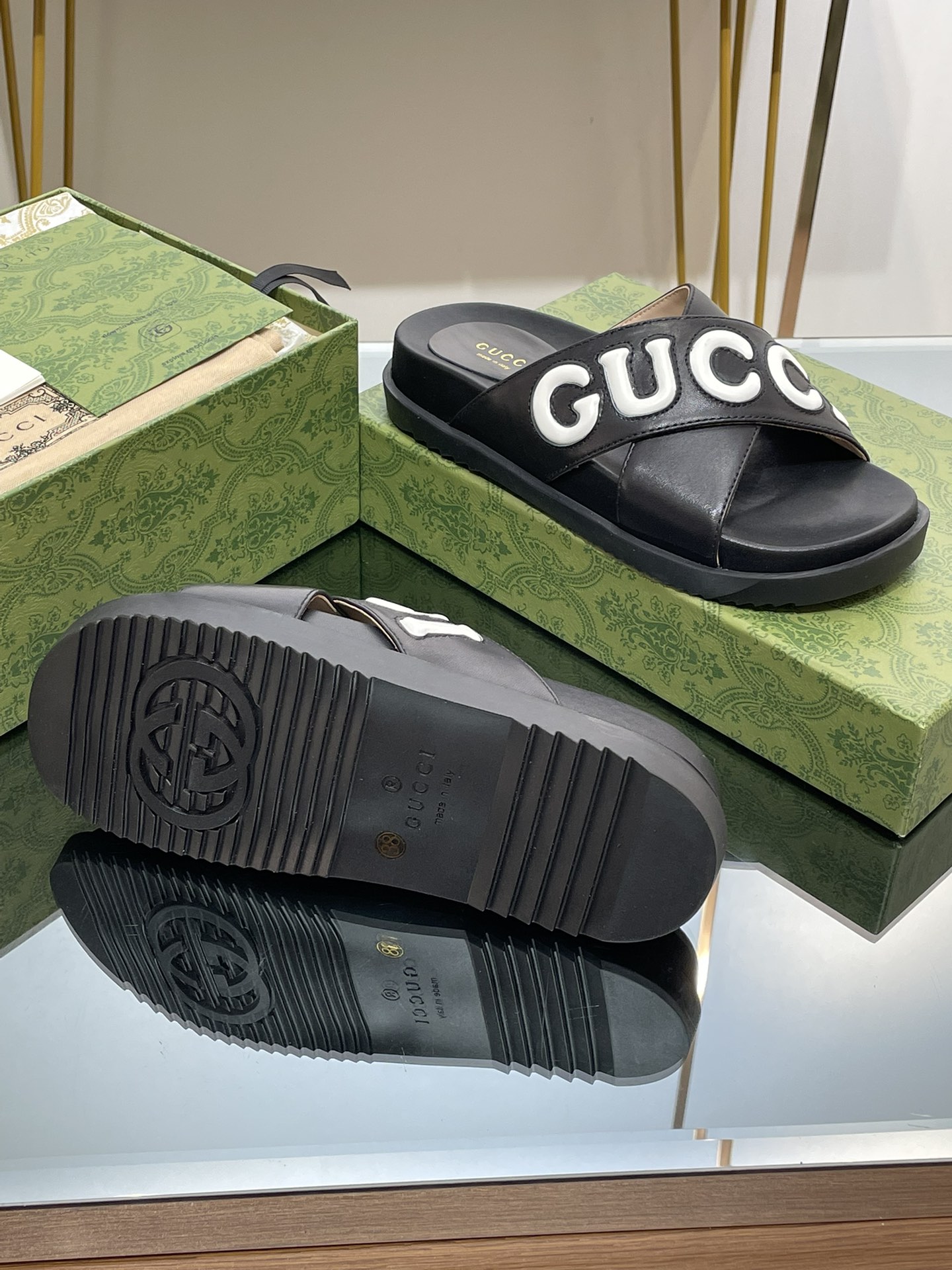 Gucci slippers with large logo lettering cross straps