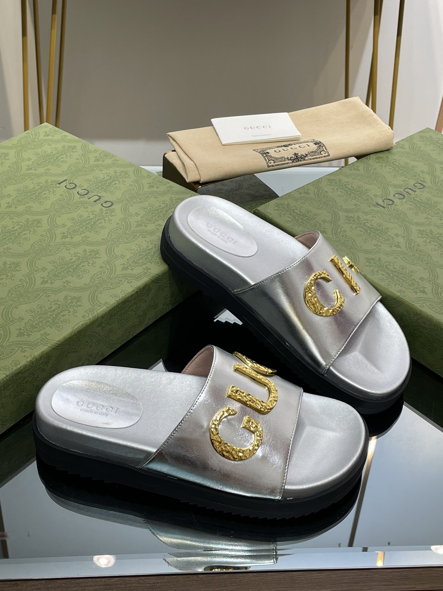 Gucci slippers with gold logo lettering buckle