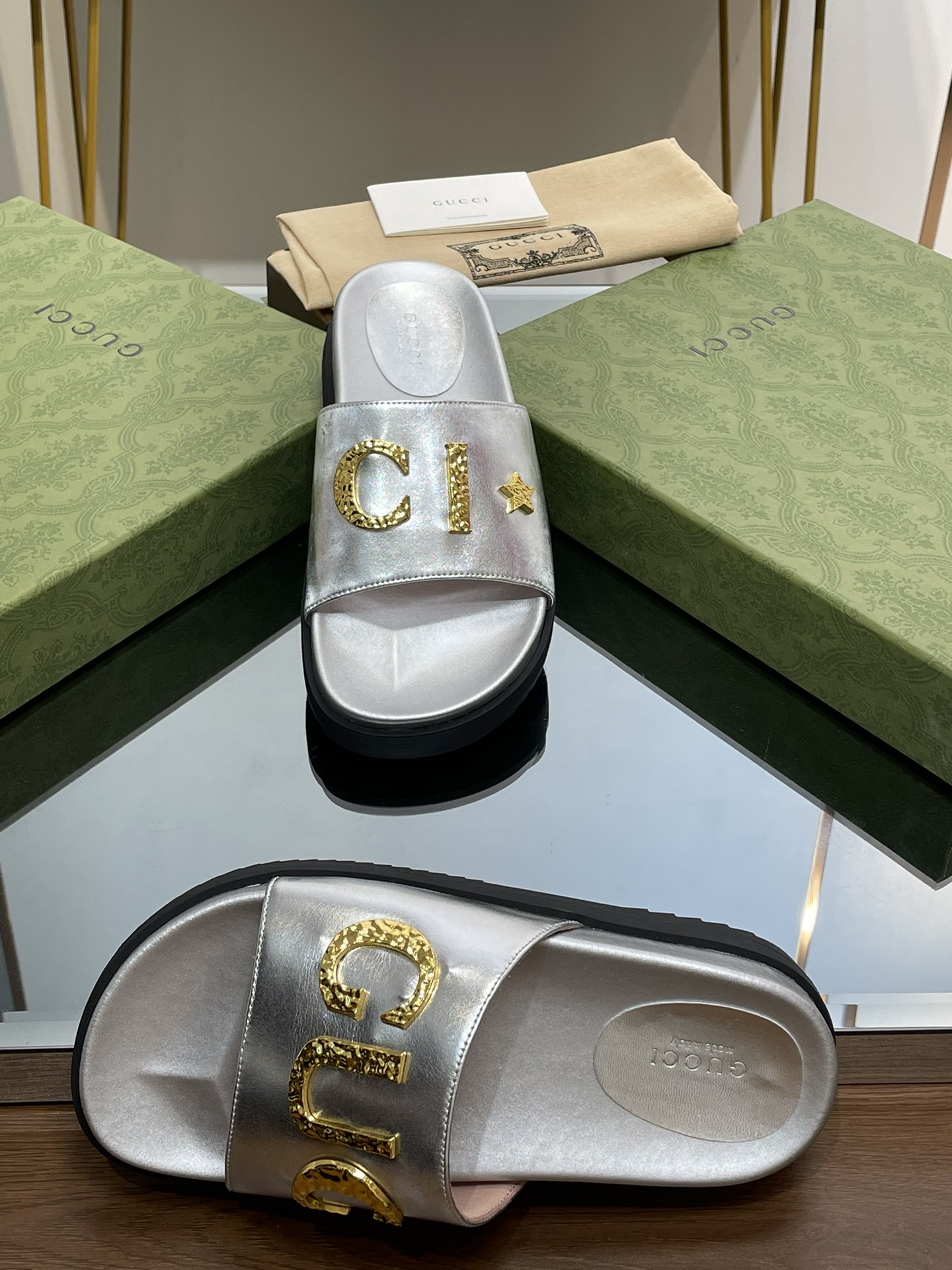 Gucci slippers with gold logo lettering buckle