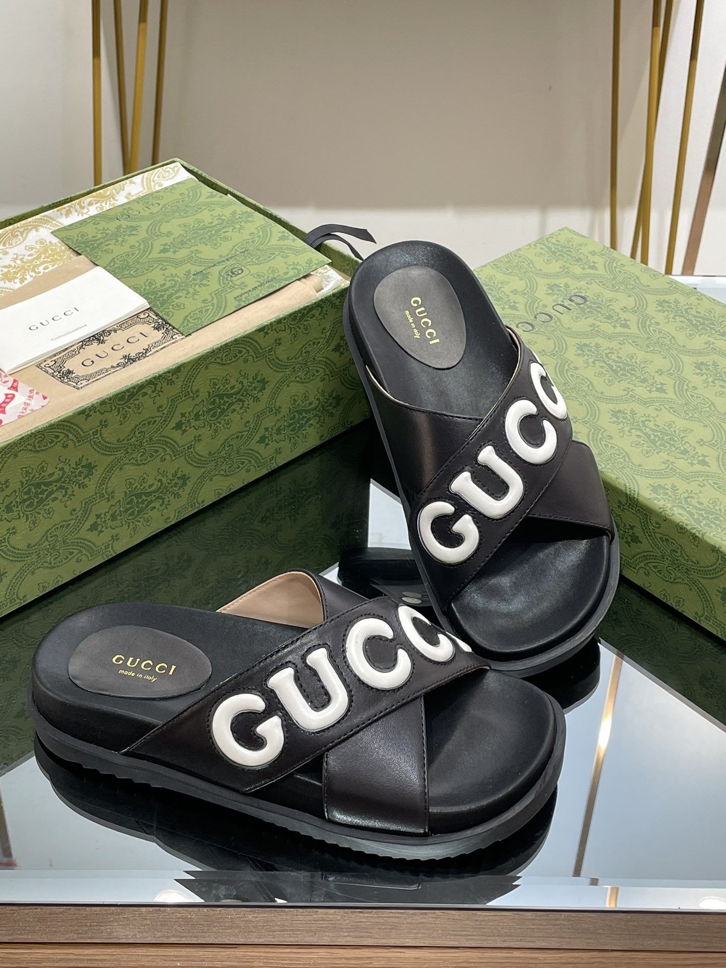 Gucci slippers with large logo lettering cross straps