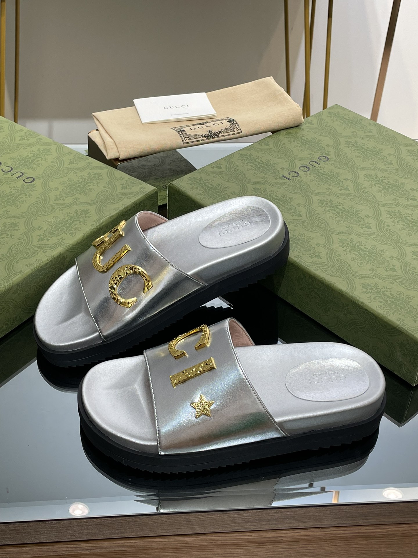 Gucci slippers with gold logo lettering buckle