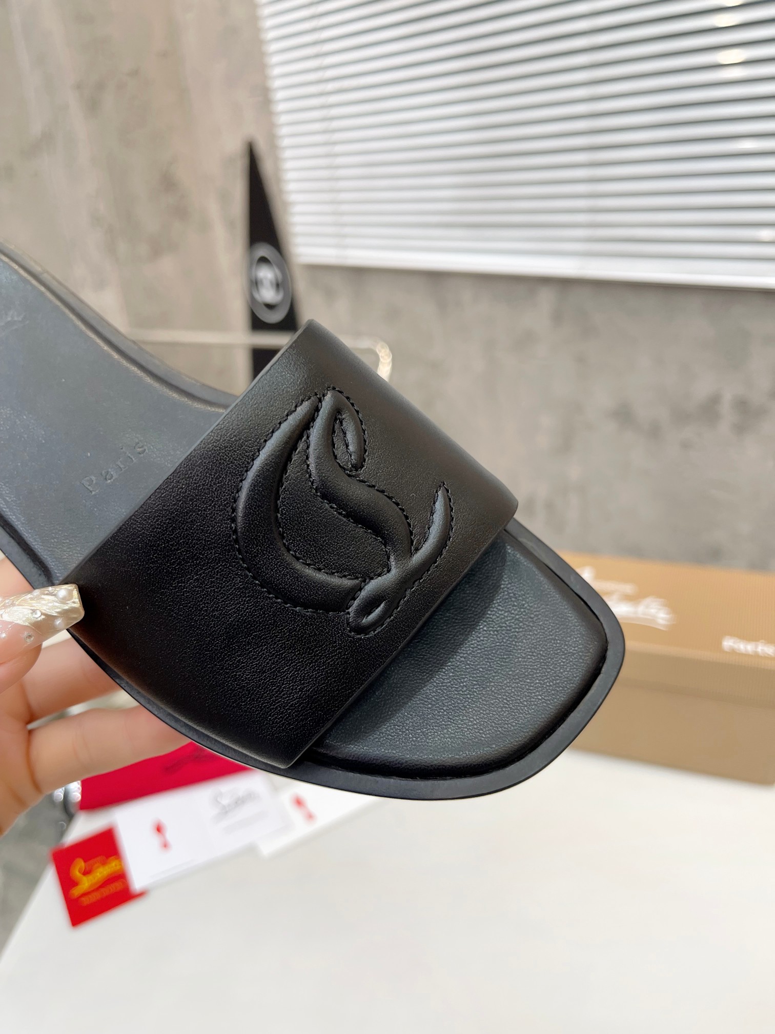 Christian Louboutin (CL) slippers with red soles