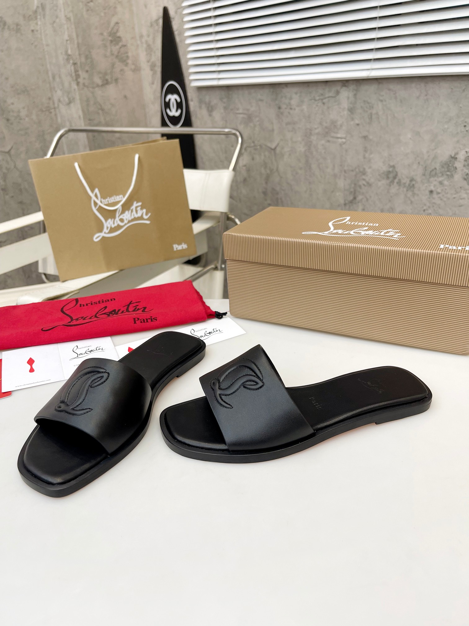 Christian Louboutin (CL) slippers with red soles