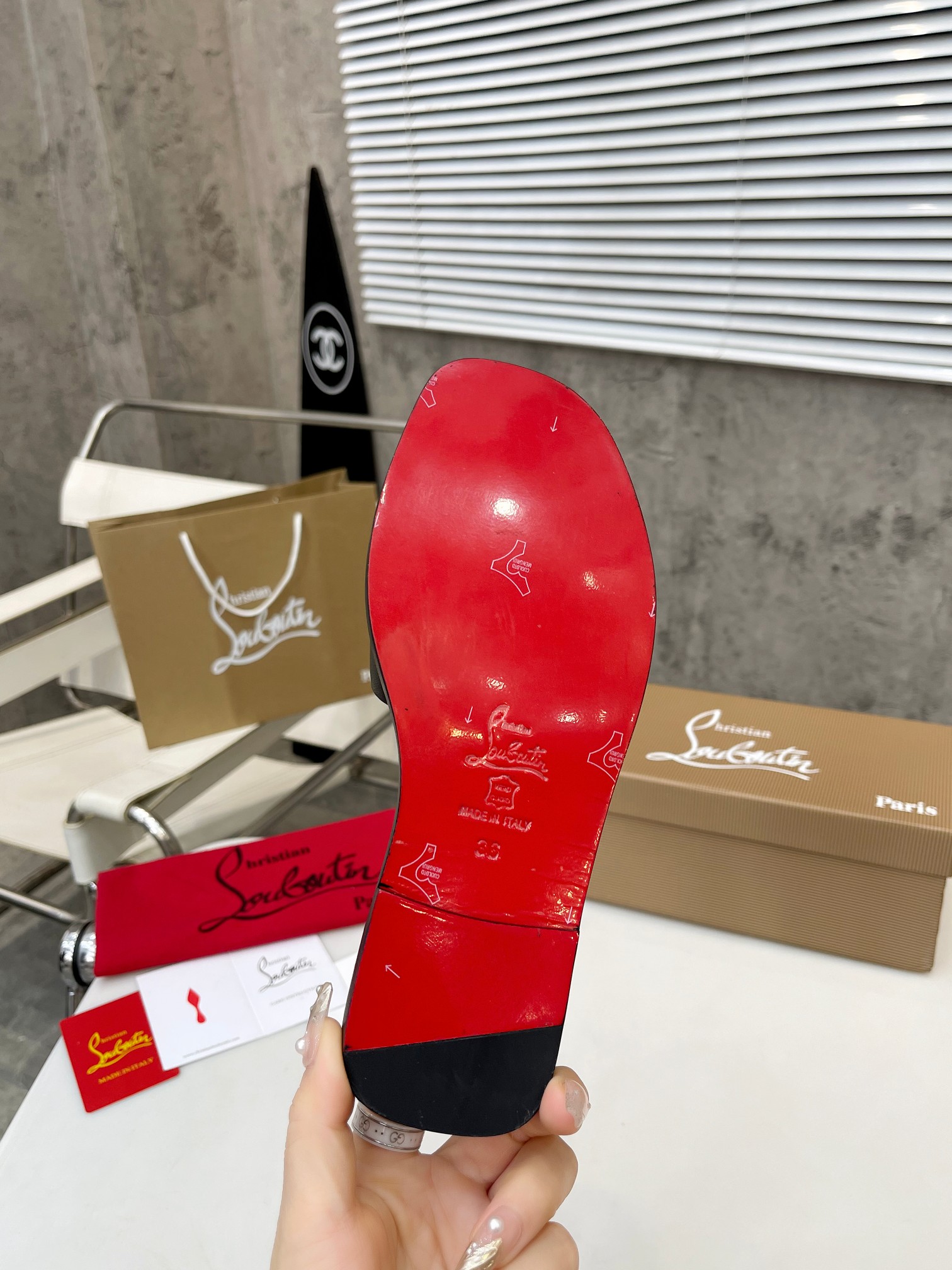 Christian Louboutin (CL) slippers with red soles