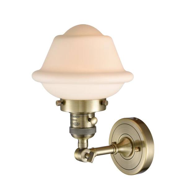 Oxford 1-Light Antique Brass Wall Sconce with Matte White Glass Shade